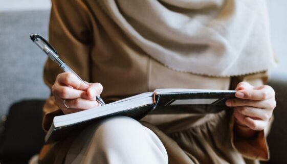 muslim woman writing notebook 7520627